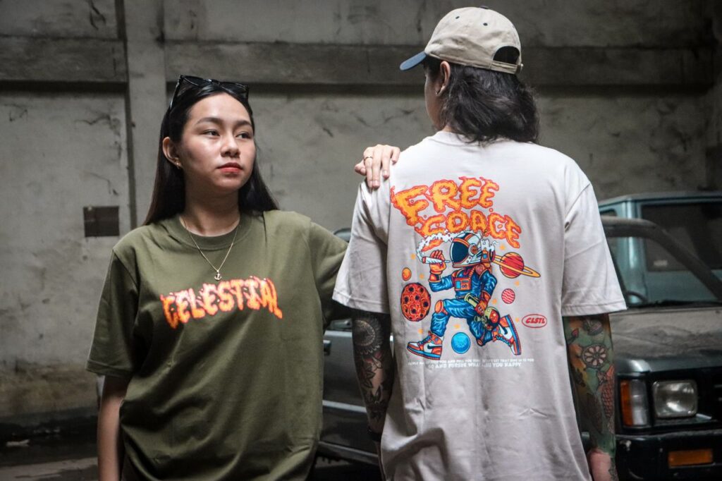 Asian individuals showcasing colorful graphic tees in an urban setting.