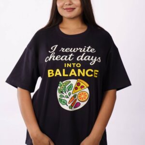 Smiling woman wearing oversized printed t-shirt promoting cheat day balance in Delhi studio.